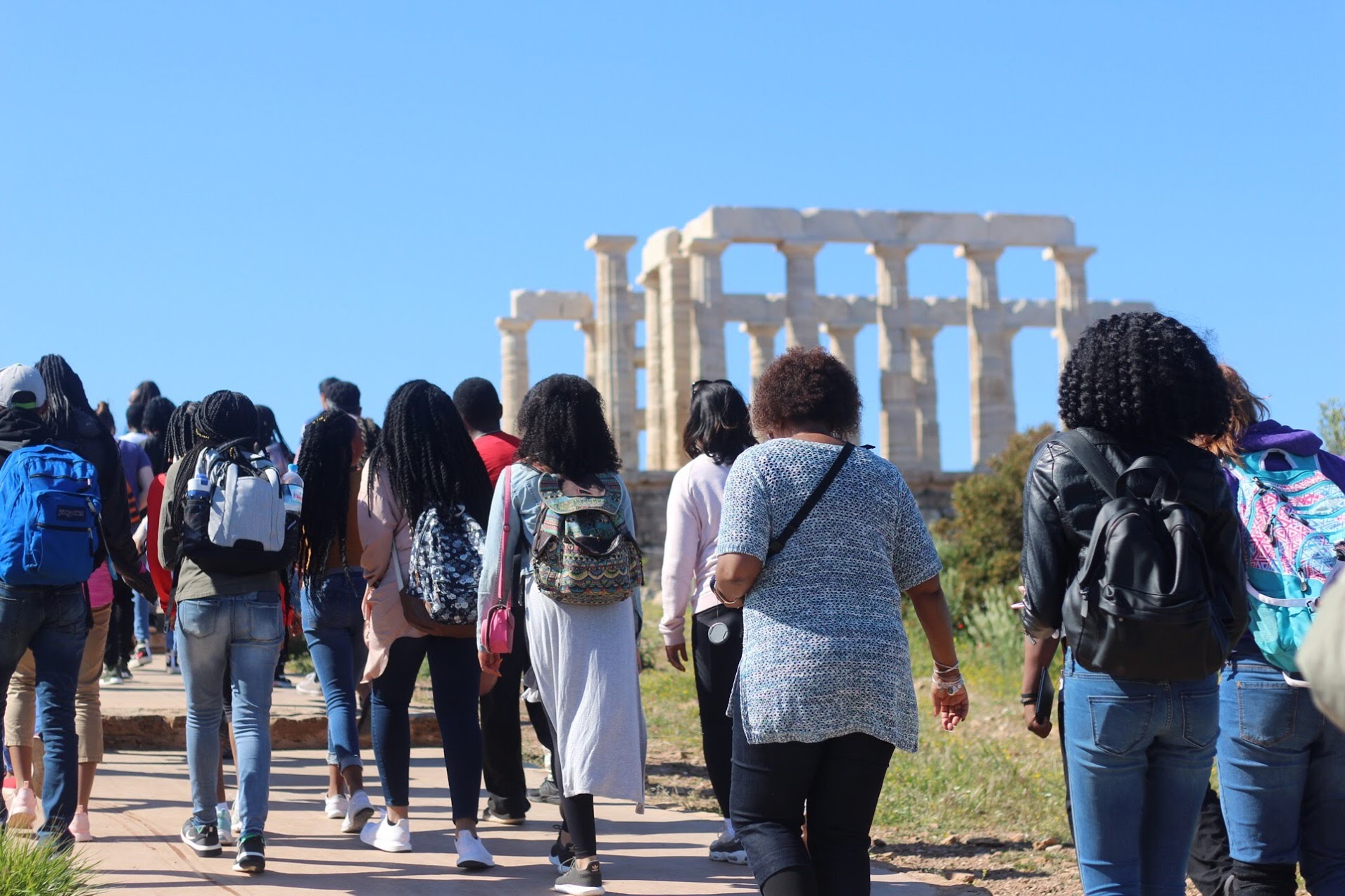 U in Greece April 2018. Group walking up to ruins.