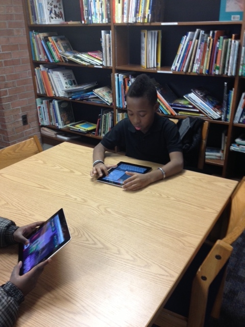 3rd boy grade learns using iPads.
